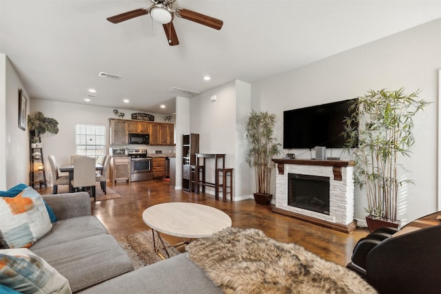 living room with ceiling fan, dark hardwood / wood-style floors, and a fireplace