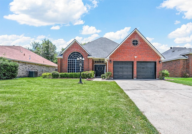 front facade featuring cooling unit, a garage, and a front yard