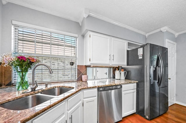 kitchen featuring white cabinets, sink, stainless steel dishwasher, plenty of natural light, and fridge with ice dispenser