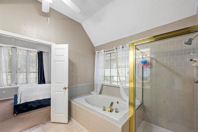 bathroom with a textured ceiling, a wealth of natural light, and vaulted ceiling