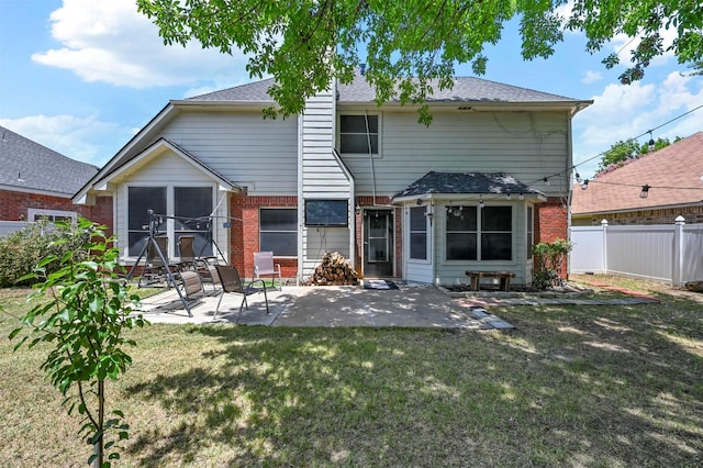 back of property featuring a yard and a patio