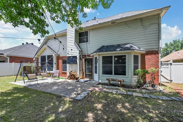 back of property with a patio area and a yard