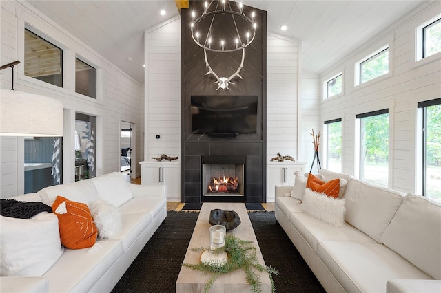 living room with hardwood / wood-style flooring, a large fireplace, wooden ceiling, and high vaulted ceiling