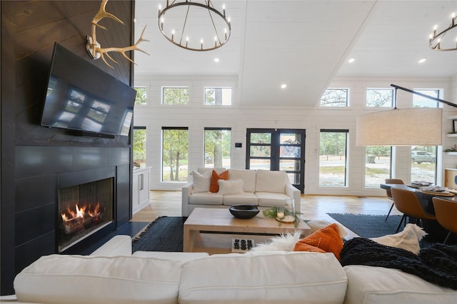 living room with a fireplace, plenty of natural light, and light hardwood / wood-style flooring