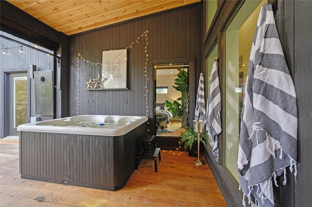 exterior space featuring wood ceiling and a hot tub