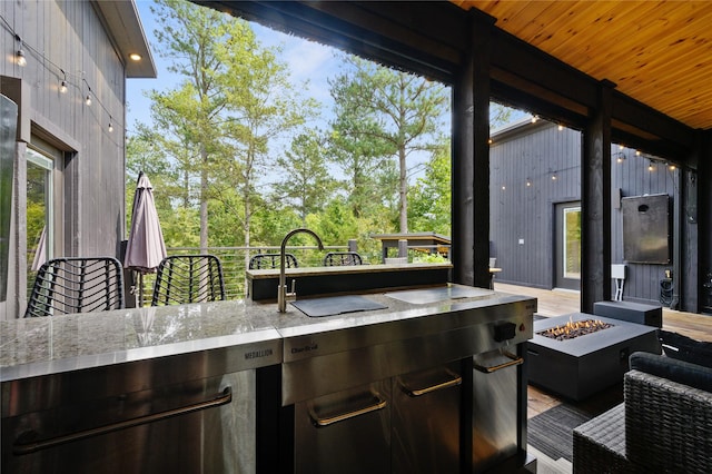 view of patio featuring an outdoor bar and a fire pit