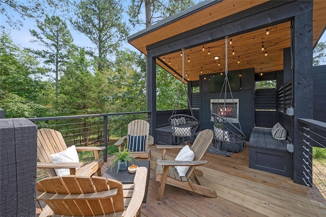 deck featuring exterior fireplace