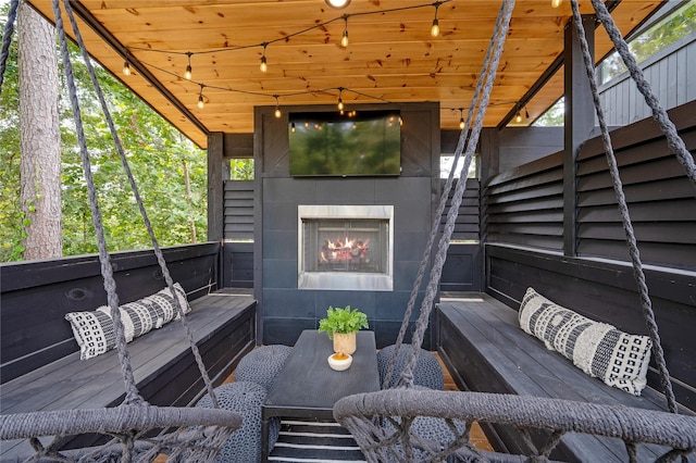 wooden deck featuring a tile fireplace