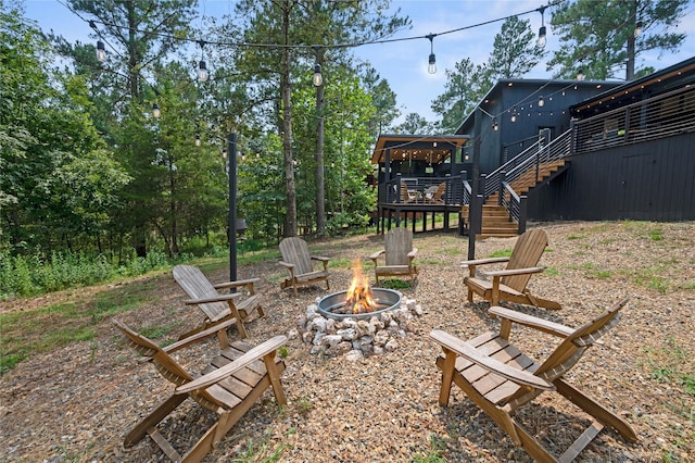 view of yard with a fire pit and a deck