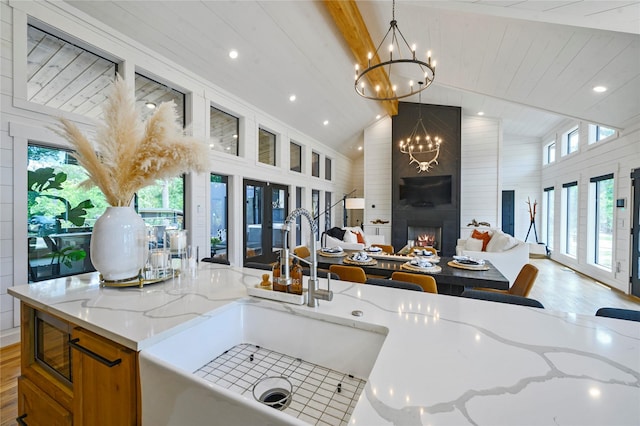 kitchen with a fireplace, plenty of natural light, and hanging light fixtures