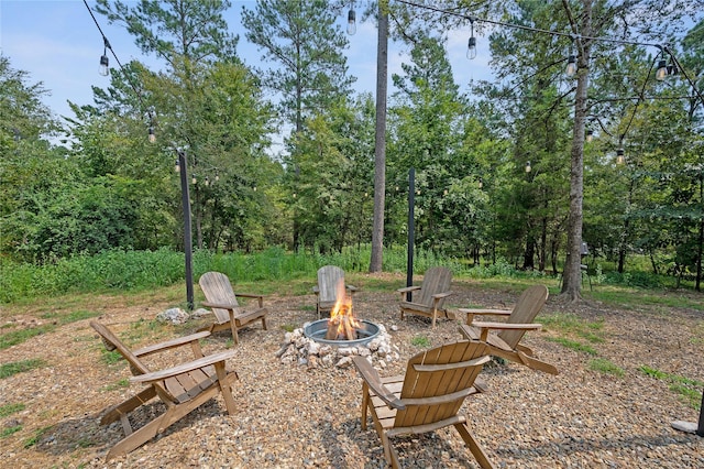 view of yard featuring an outdoor fire pit