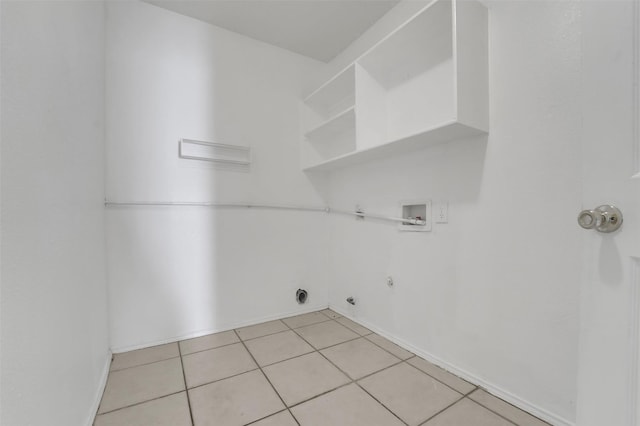 laundry area with hookup for an electric dryer, hookup for a washing machine, hookup for a gas dryer, and light tile patterned flooring