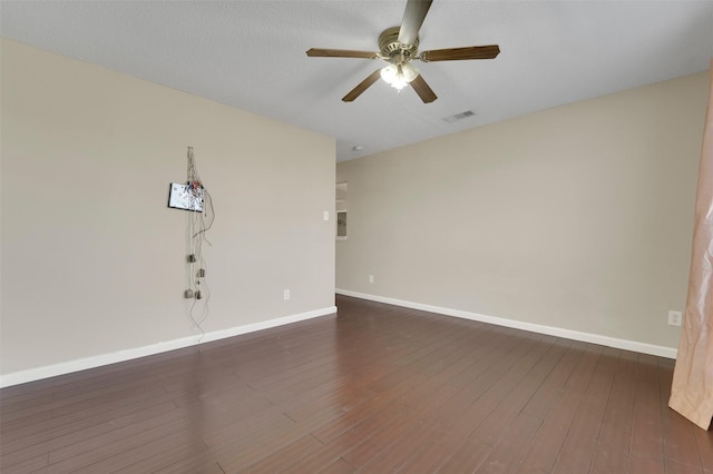 spare room featuring a textured ceiling, ceiling fan, and dark hardwood / wood-style floors