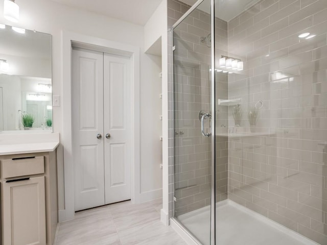 bathroom featuring vanity and an enclosed shower