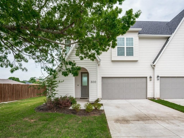 view of front of house with a front yard and a garage