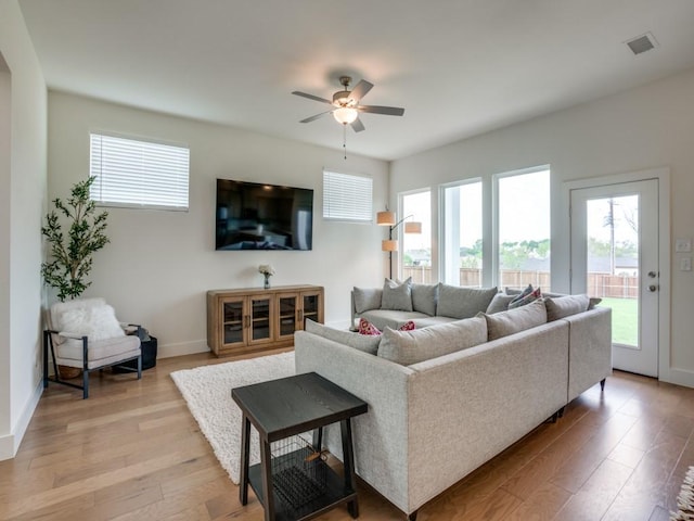 living room featuring ceiling fan and light wood-type flooring