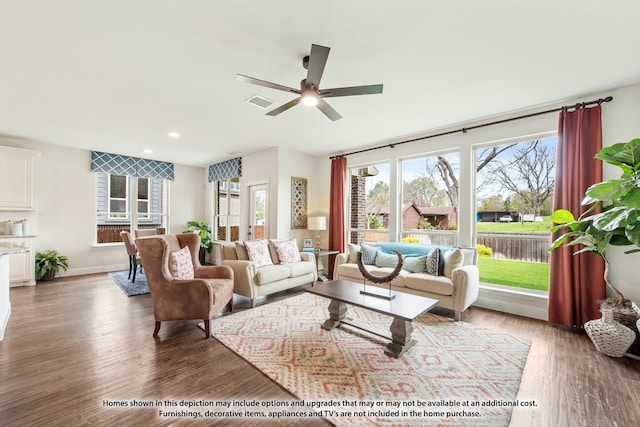 living room with ceiling fan and dark hardwood / wood-style flooring