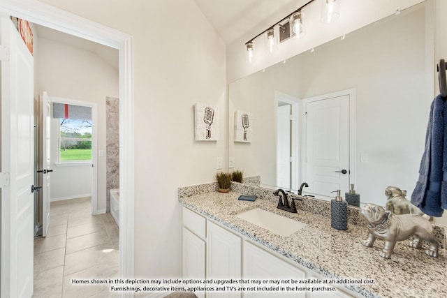 bathroom featuring tile patterned flooring, vanity, and lofted ceiling