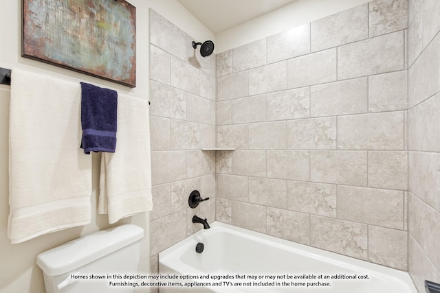 bathroom with tiled shower / bath combo and toilet