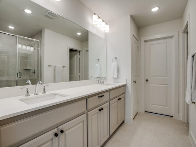 bathroom featuring tile patterned floors, vanity, and an enclosed shower