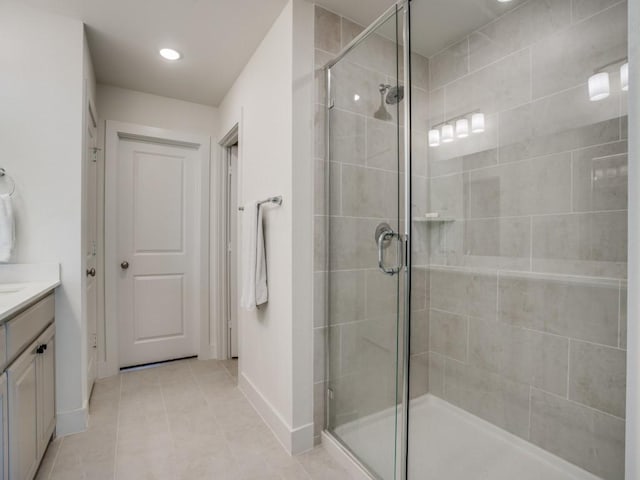 bathroom featuring vanity, tile patterned floors, and a shower with shower door