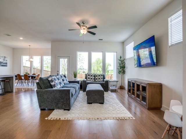 living room featuring ceiling fan and hardwood / wood-style floors