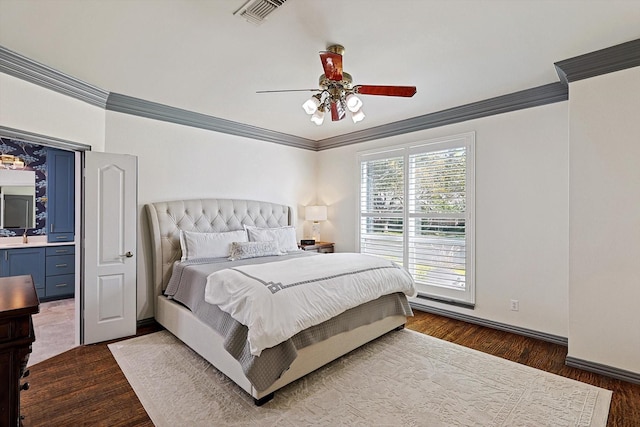 bedroom featuring dark hardwood / wood-style flooring, ceiling fan, crown molding, and connected bathroom