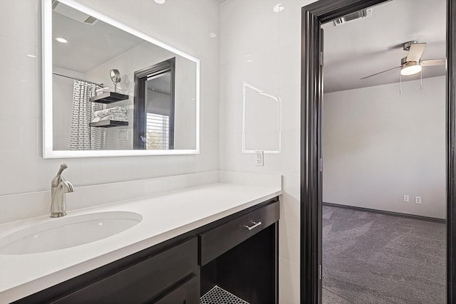 bathroom featuring a shower with shower curtain, vanity, and ceiling fan