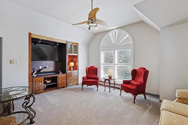 living area featuring carpet flooring, ceiling fan, and lofted ceiling