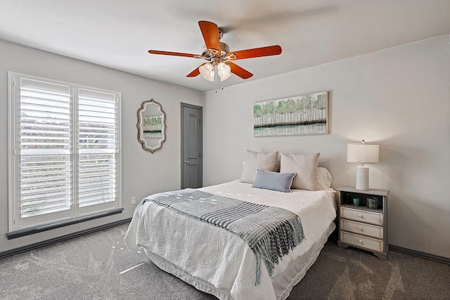 bedroom with ceiling fan and dark carpet