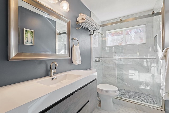 bathroom with vanity, a shower with shower door, and toilet