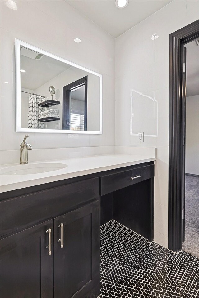 bathroom with tile patterned flooring, vanity, and curtained shower