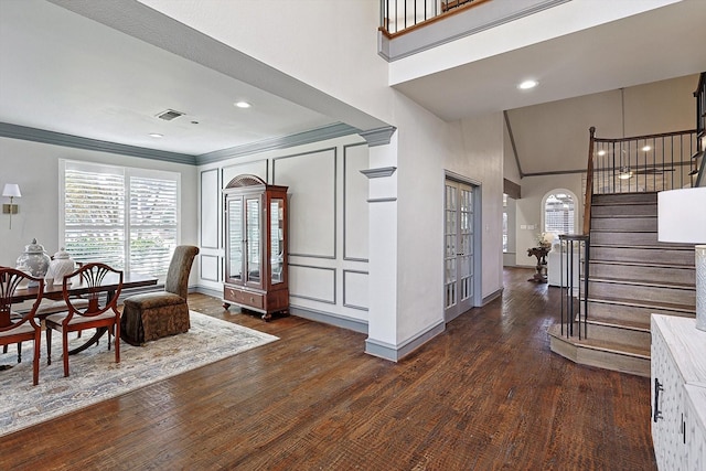 dining space featuring crown molding, high vaulted ceiling, and dark hardwood / wood-style floors