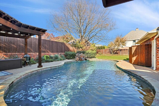 view of pool featuring a grill