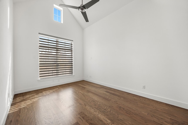 empty room with ceiling fan, dark wood-type flooring, and high vaulted ceiling