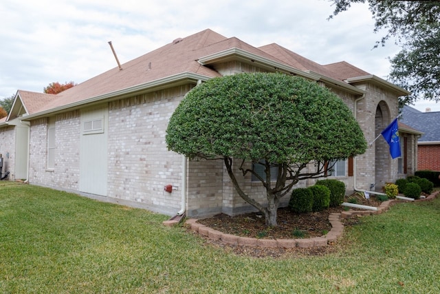 view of side of home featuring a lawn