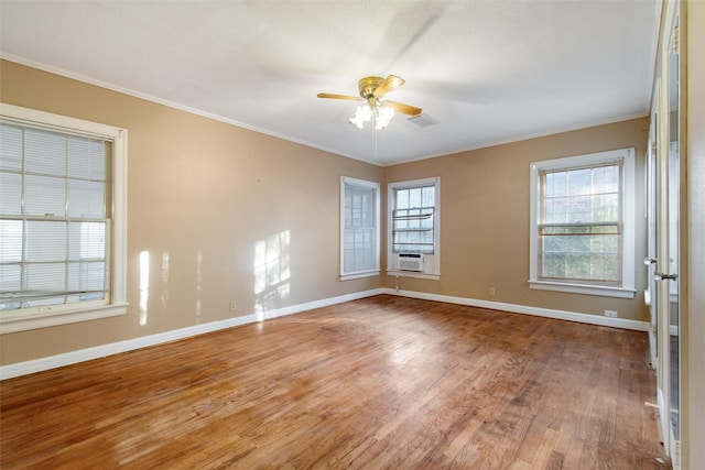 unfurnished room with ornamental molding, baseboards, ceiling fan, and wood finished floors