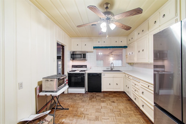 kitchen featuring sink, stainless steel appliances, light parquet flooring, backsplash, and white cabinets