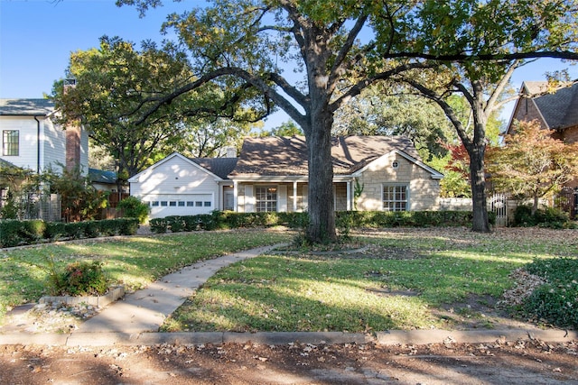 view of front of home featuring a garage, stone siding, and a front yard