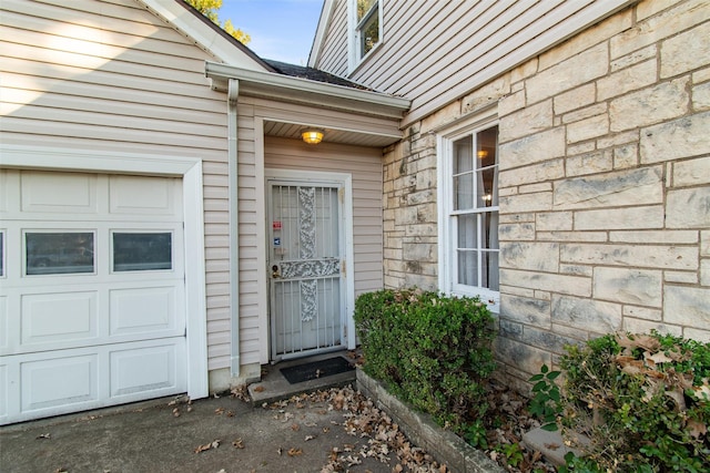 view of exterior entry featuring a garage