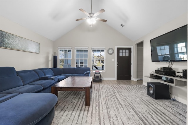 living room featuring ceiling fan, vaulted ceiling, and light wood-type flooring