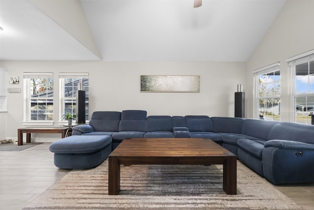 living room featuring lofted ceiling and light hardwood / wood-style flooring