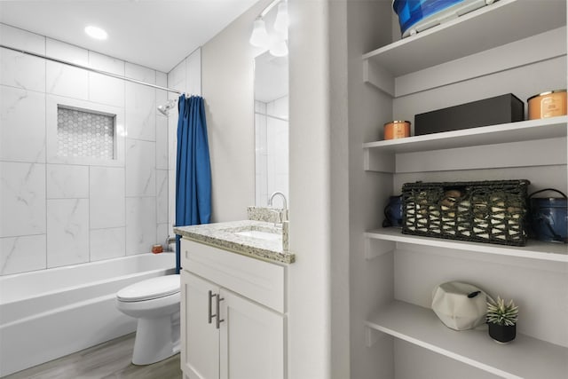 full bathroom with toilet, vanity, shower / bathtub combination with curtain, and hardwood / wood-style floors