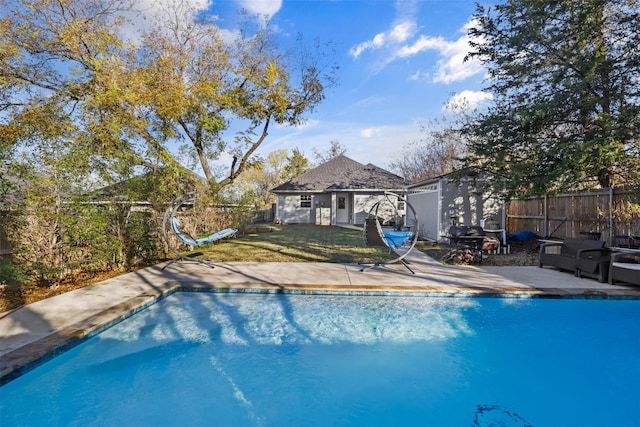 view of pool featuring a yard and a storage unit