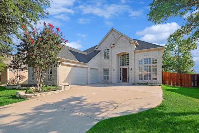 view of front of house with a garage and a front lawn