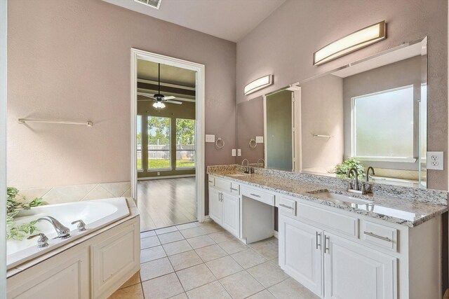 bathroom featuring a tub to relax in, ceiling fan, tile patterned flooring, and vanity