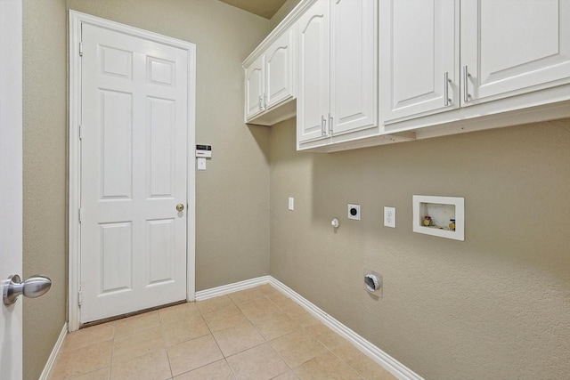 clothes washing area featuring washer hookup, cabinets, hookup for an electric dryer, hookup for a gas dryer, and light tile patterned floors