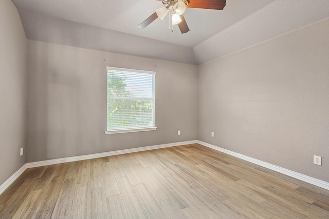 unfurnished room with ceiling fan, light hardwood / wood-style floors, and lofted ceiling