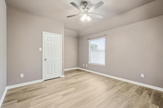 spare room featuring light wood-type flooring and ceiling fan