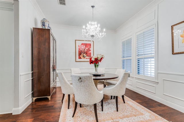 dining area featuring ornamental molding, an inviting chandelier, and dark wood-type flooring